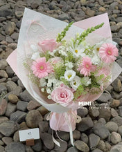 Load image into Gallery viewer, Bouquet of pink and white flowers with a pink wrap on pebbles, featuring &#39;MINI Concept&#39; branding.
